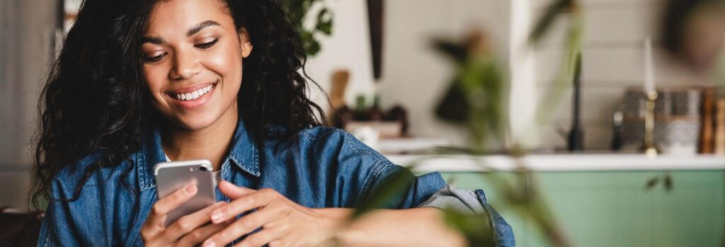 Female prioritizing her mental health and laughing at her phone