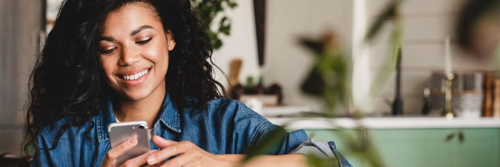 Female prioritizing her mental health and laughing at her phone